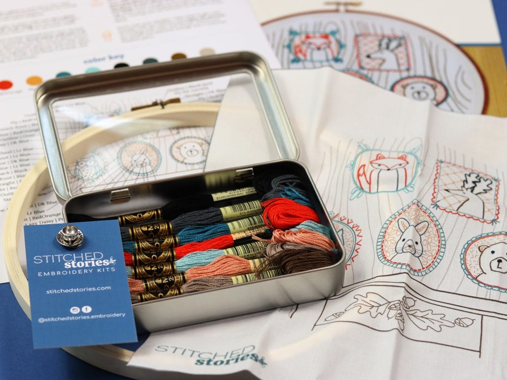 All-in-one embroidery kit with stitcher's tin, embroidery floss, embroidery pattern, hoop and stitching guide. 