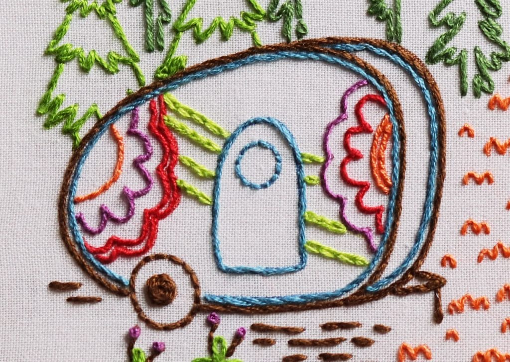 closeup of whipped back stitch used to outline the camper in outdoor-themed embroidery design