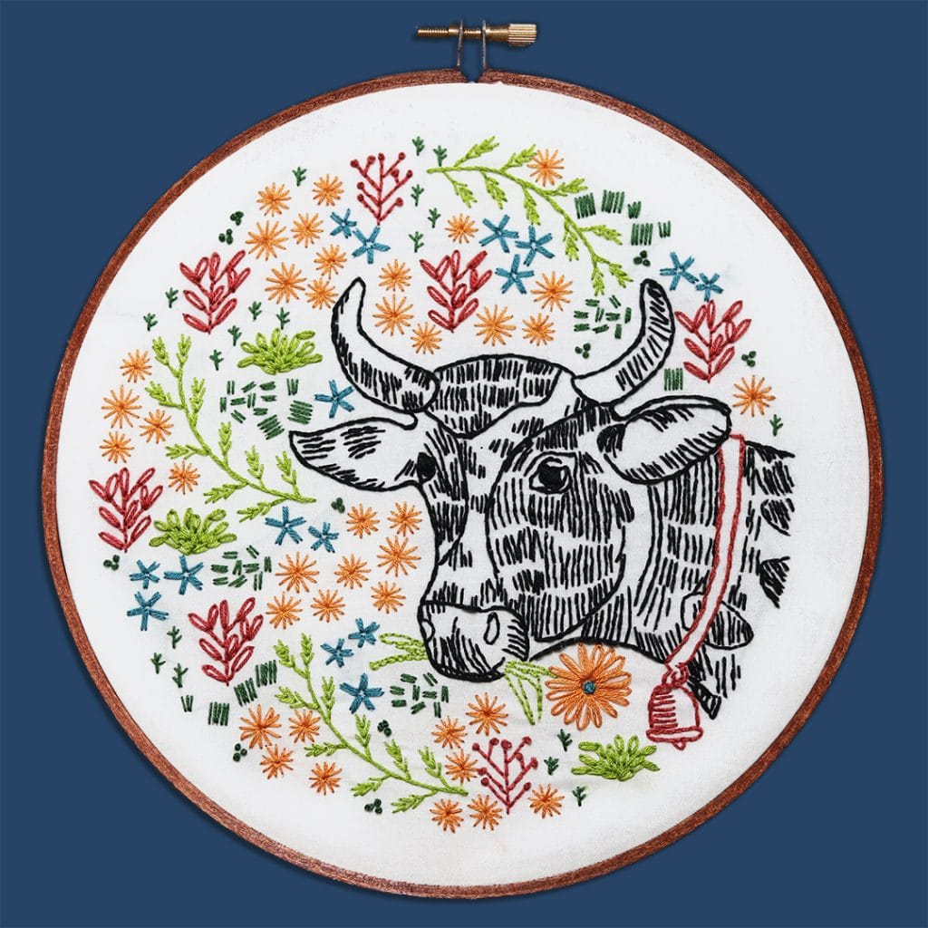 farm-themed embroidery hoop art with cow and flowers