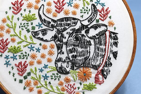 farm-inspired embroidery hoop art with cow and flowers