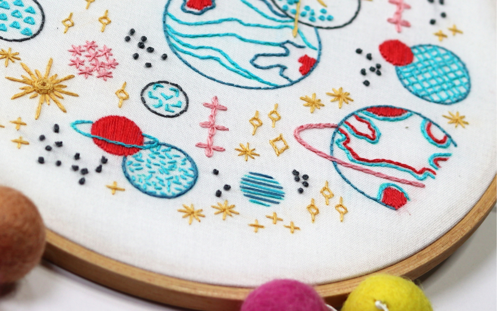closeup of chain stitch used to emphasize the rings on the planets in this space-themed embroidery project