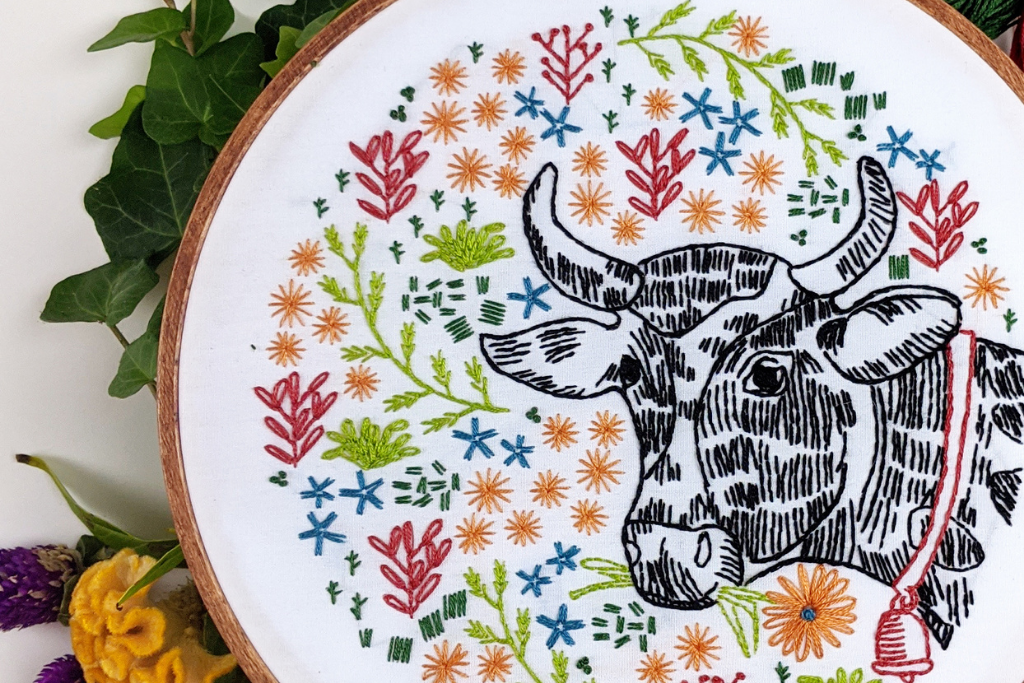 summer-inspired embroidery kit with farm-fresh flowers and Bessie the cow.