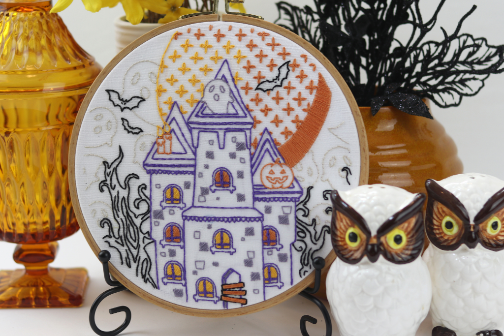 Halloween inspired embroidery patter with spooky house ghosts and bats