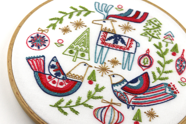 folk art-inspired holiday embroidery kit with reindeer, trees and birds