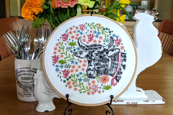 farm-themed embroidery hoop art displayed on table as centerpiece