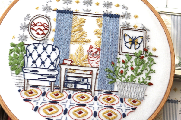 closeup of home-inspired embroidery project with chain stitch drapes