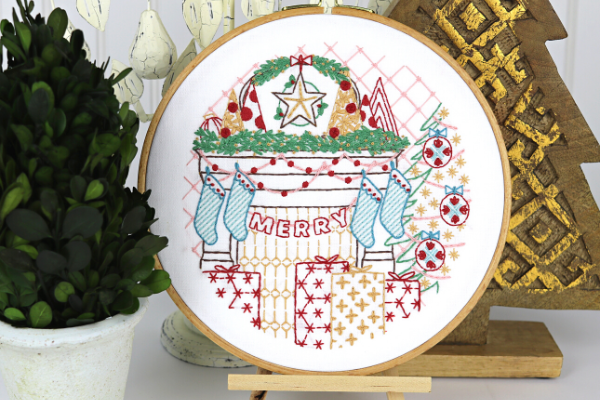 embroidery hoop art with festive Christmas mantle scene