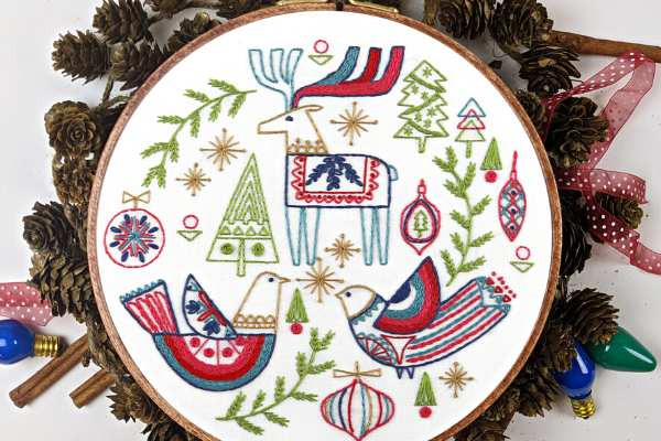 embroidery hoop art with holiday folk-art birds, trees and reindeer