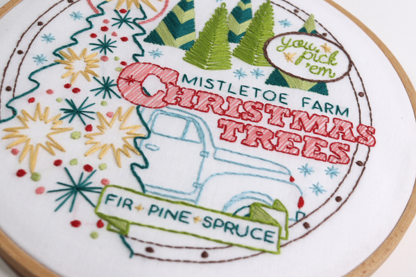 closeup of Christmas embroidery project with Christmas tree farm sign and vintage truck