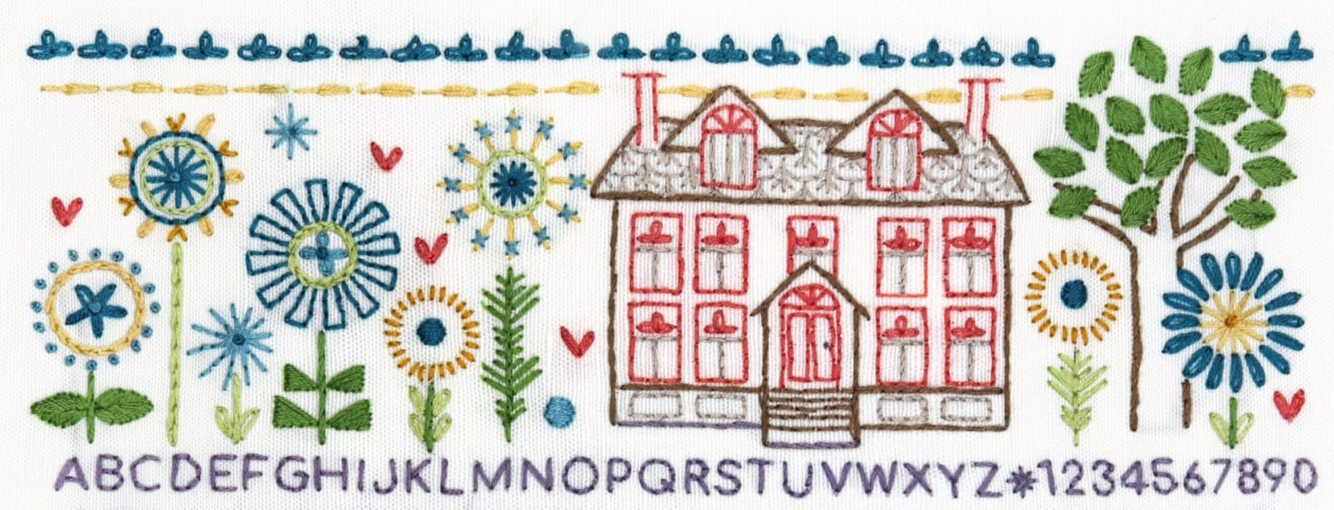 Embroidered detail from traditional embroidery stitch sampler with home themes