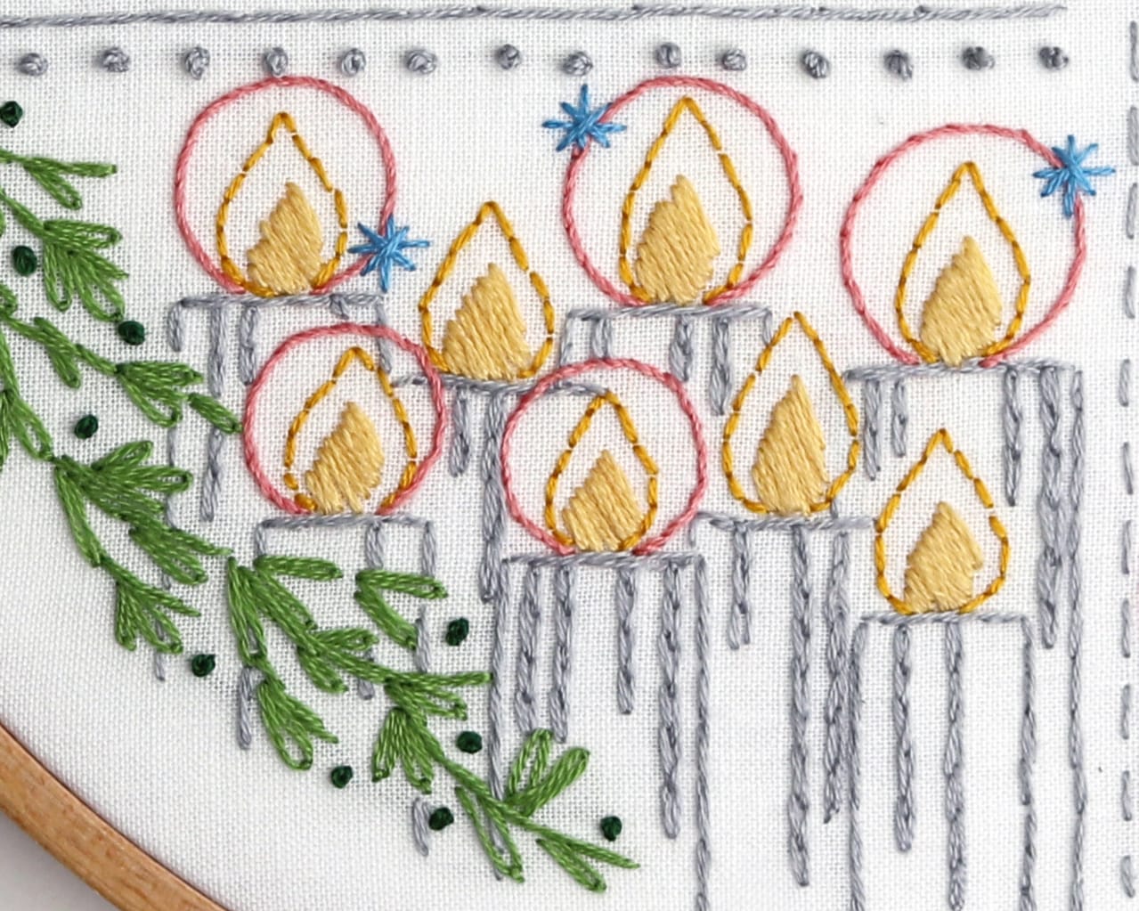 embroidery details with haloed christmas candles