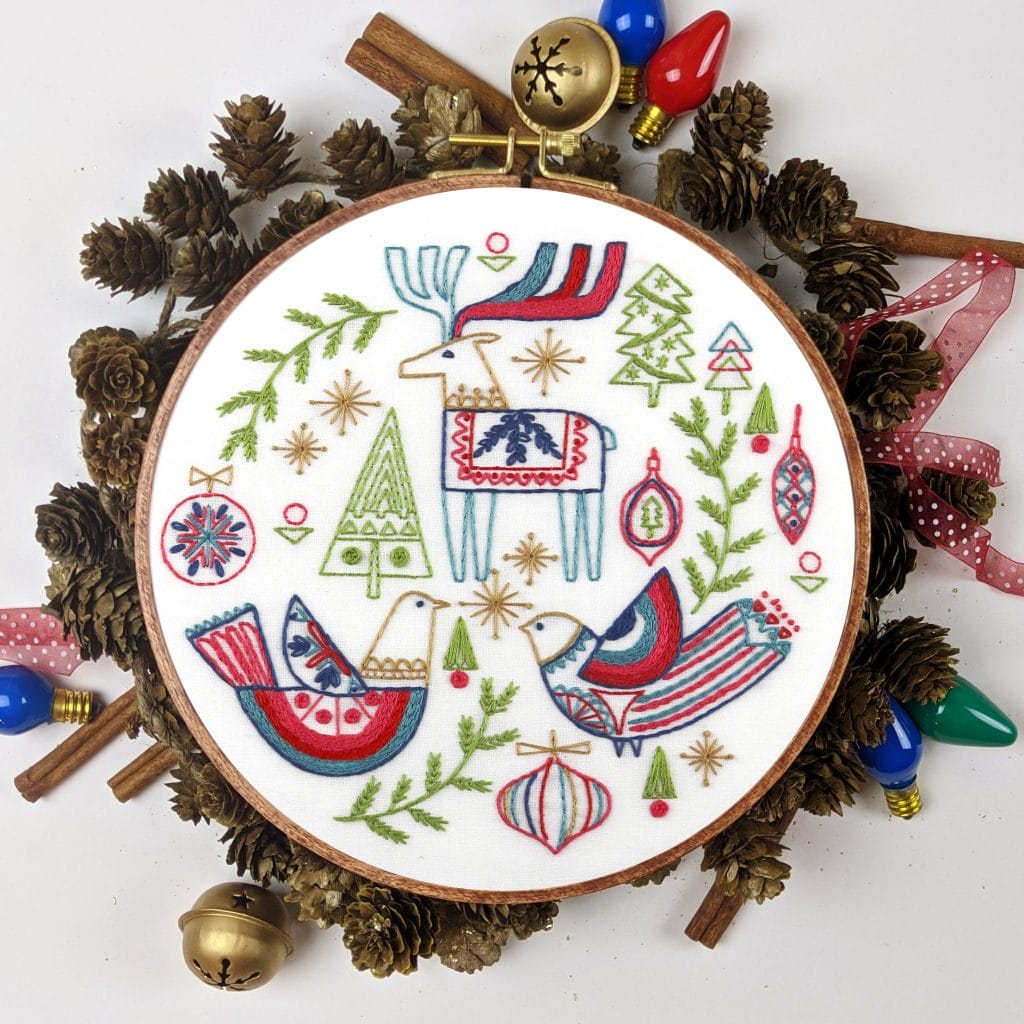 Embroidered Christmas hoop art in pinecone wreat 
