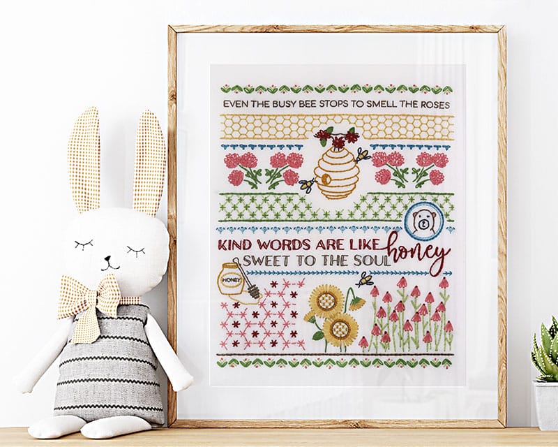 Traditional embroidery stitch sampler with honeybee themes