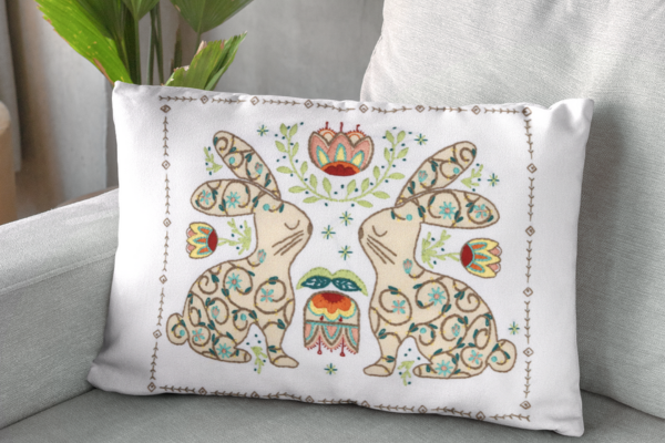 Finished embroidered pillow with folk-art bunnies