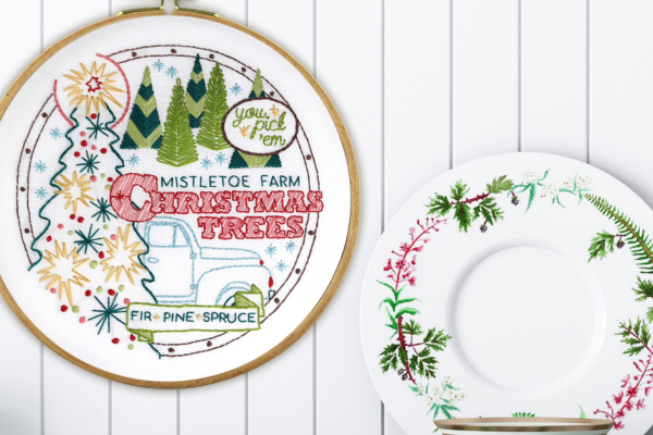 Christmas embroidery hoop-art displayed on wall next to holiday dinnerware