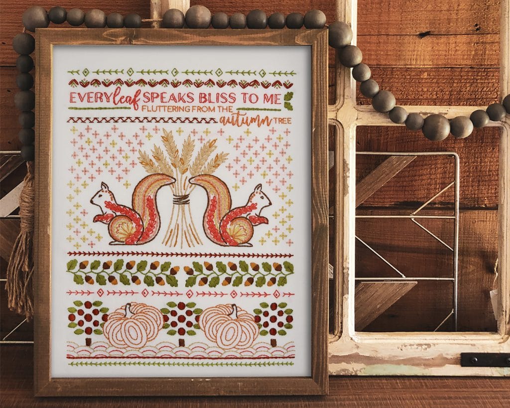 framed fall embroidery sampler with squirrels, acorns and fall saying