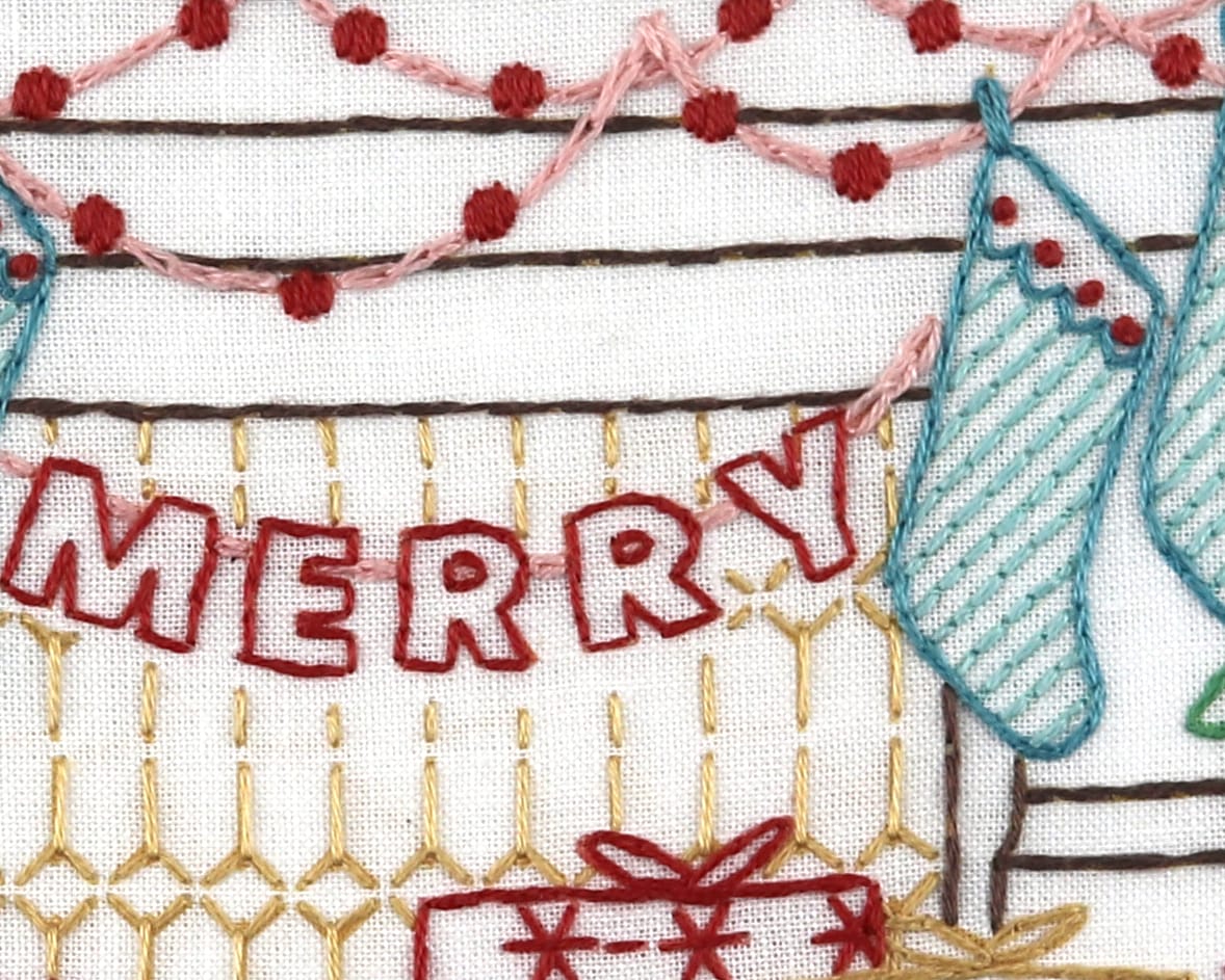 embroidered pom-pom garland and striped Christmas stockings