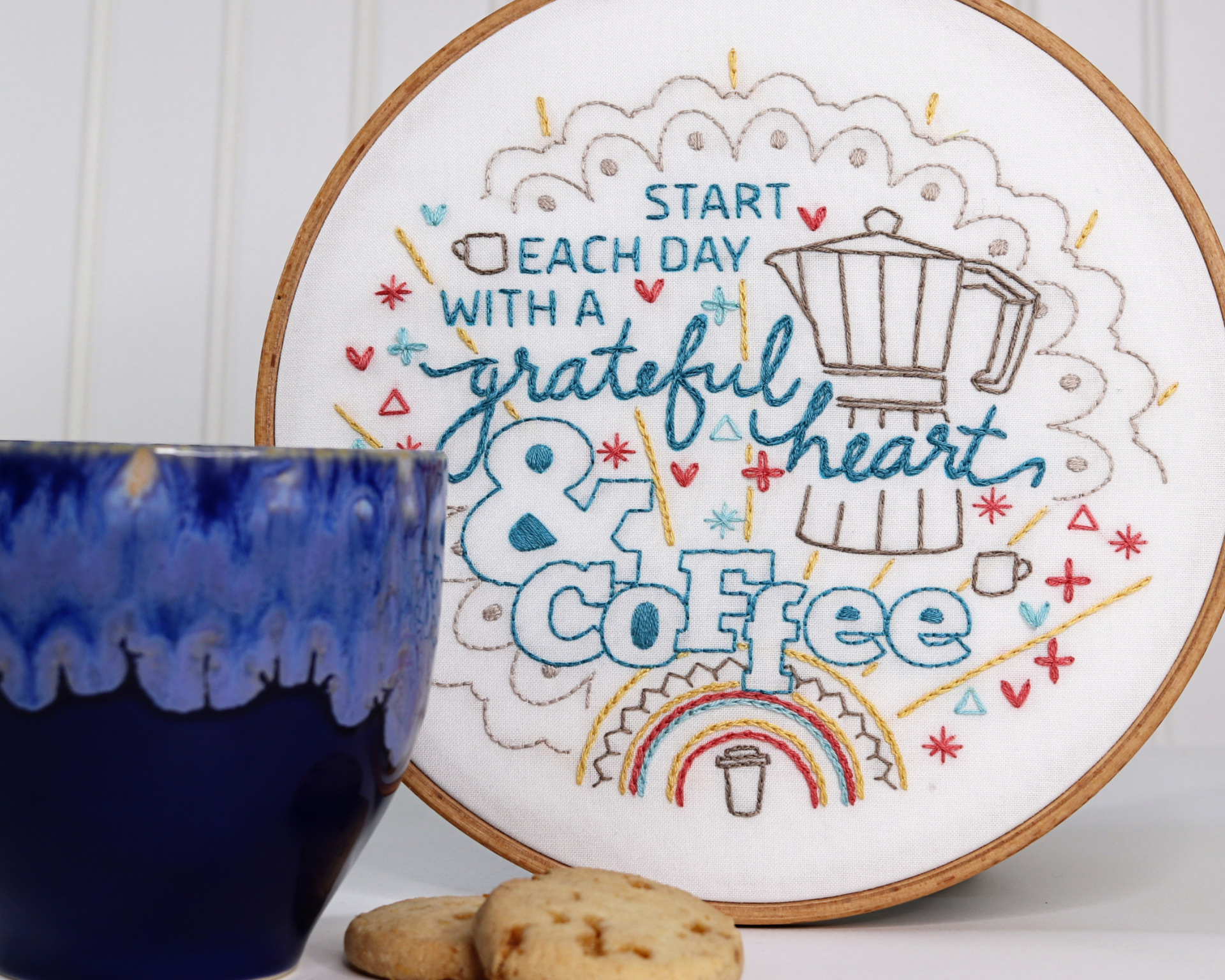 embroidered coffee-themed hoop art on display